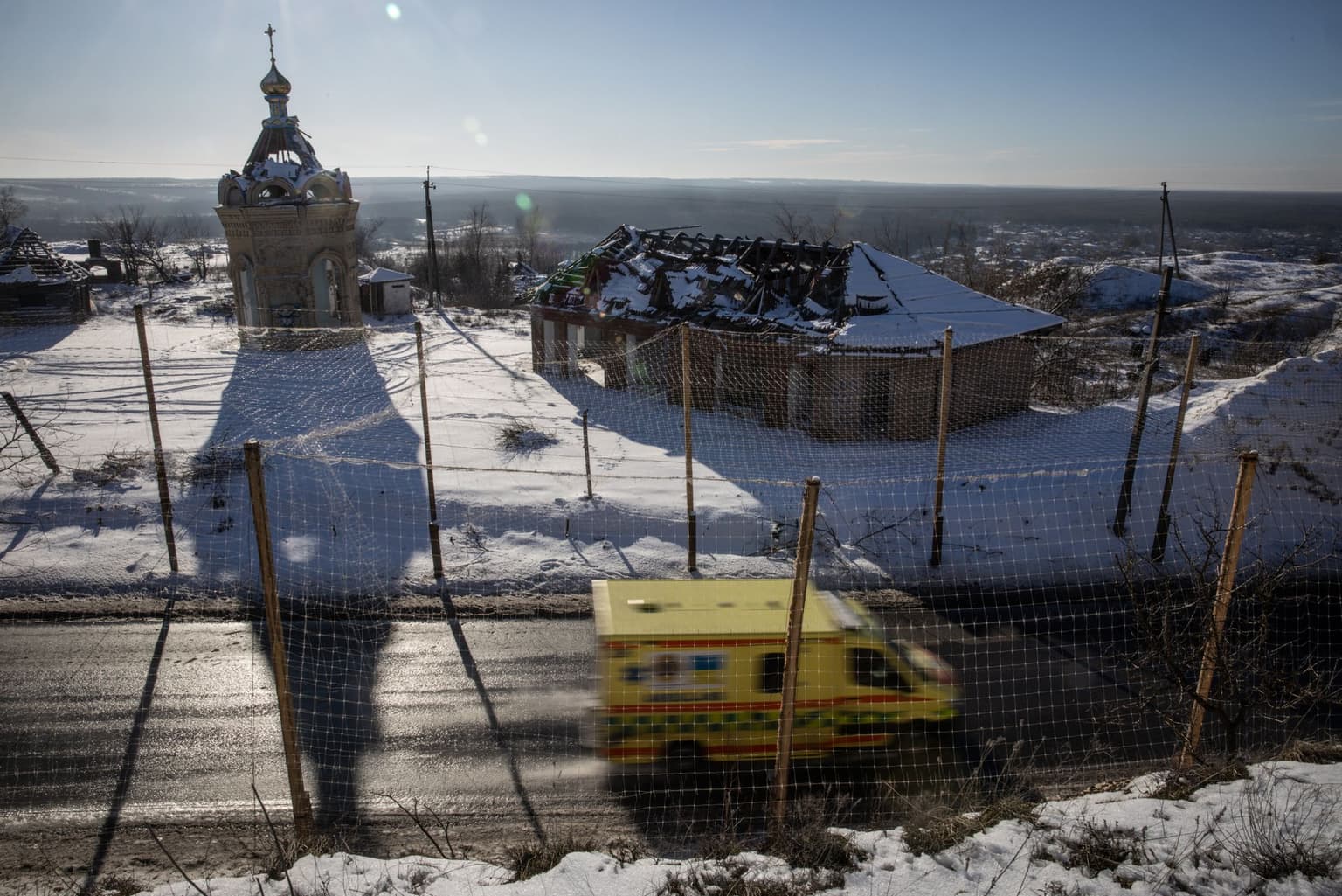 An ambulance car on a road covered in anti-drone netting in Izium, Kharkiv Oblast, Ukraine, on Feb. 22, 2026.