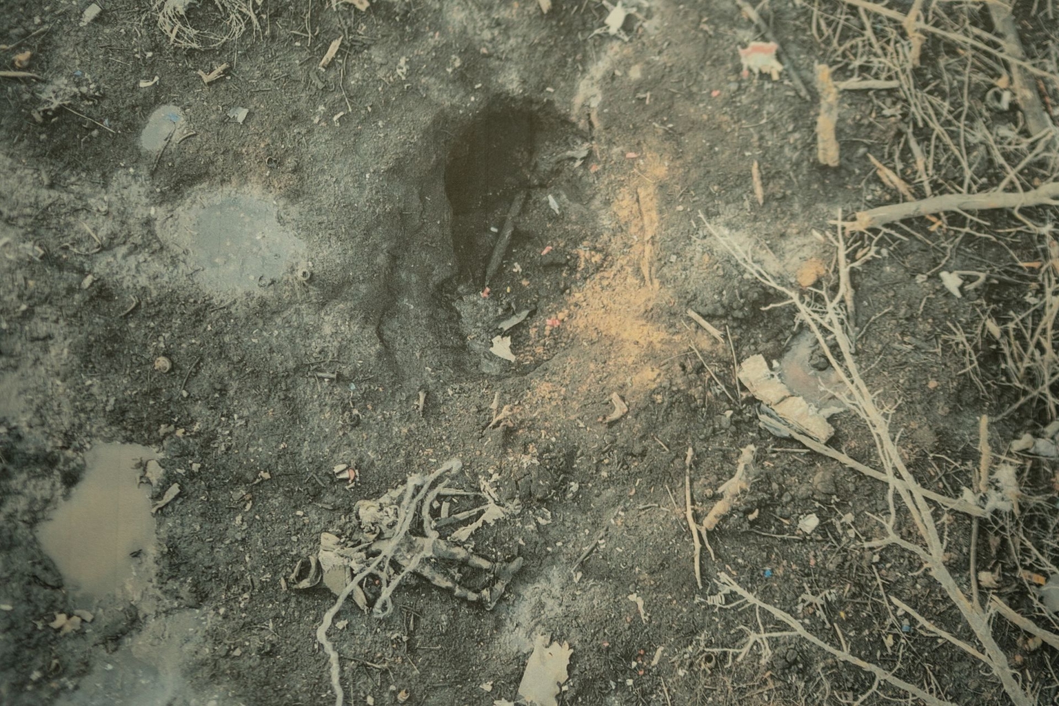 A gas pipeline exit near Kupiansk and remains of a Russian soldier depicted in a photograph at a Khartiia Brigade command post in Kharkiv Oblast, Ukraine, on April 1, 2026.