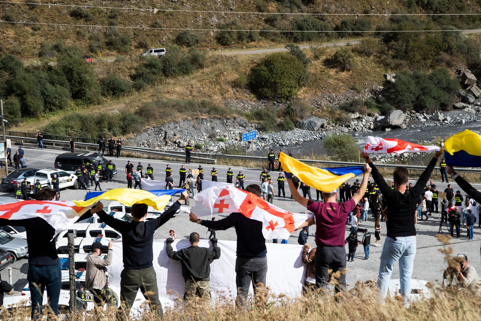 Protesters gather near the Verkhni Lars customs checkpoint between Georgia and Russia in Zemo Larsi, Georgia, on Sept. 28, 2022.