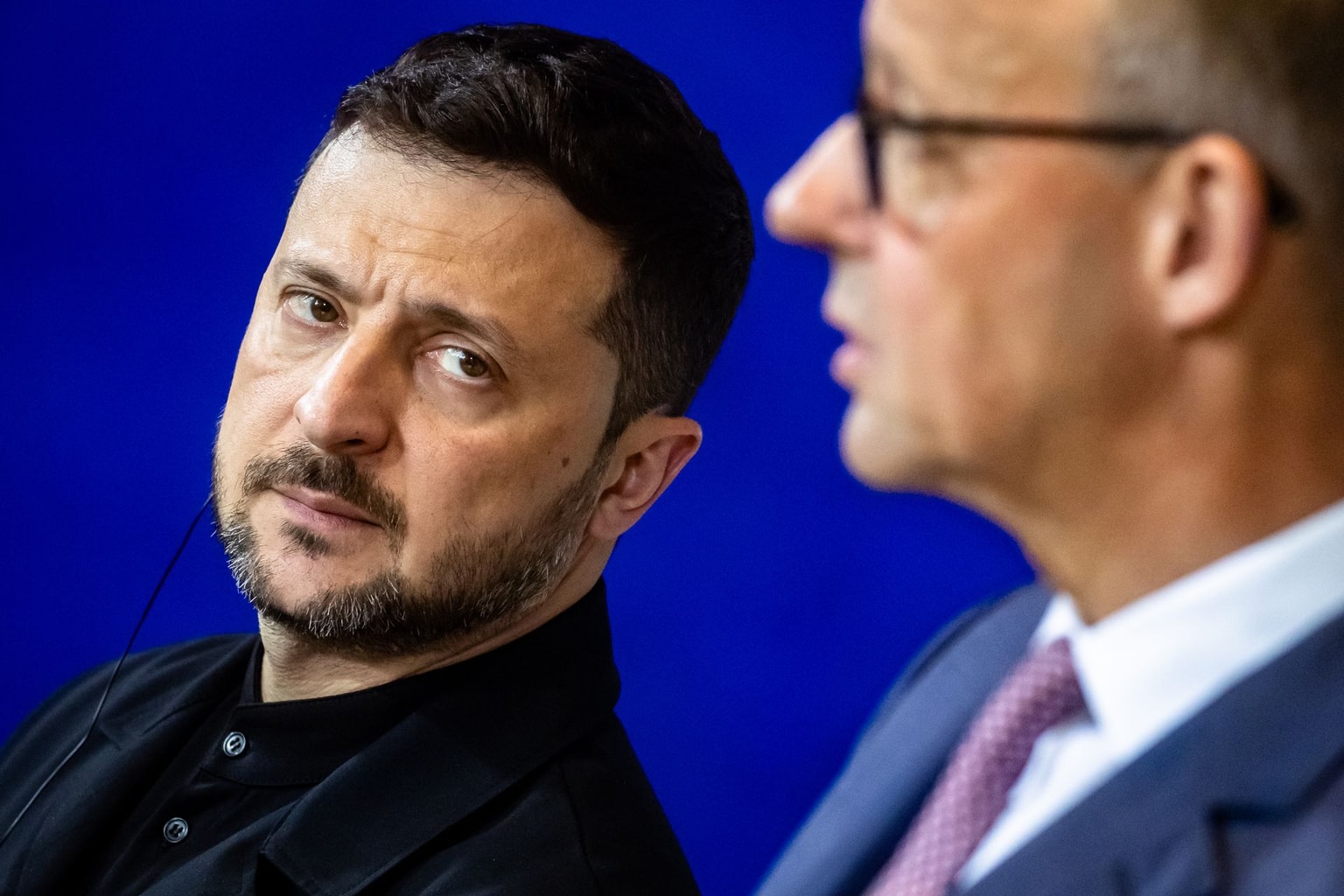 President Volodymyr Zelensky (L) looks at the German Chancellor Friedrich Merz (R) in Berlin, Germany, on May 28, 2025.