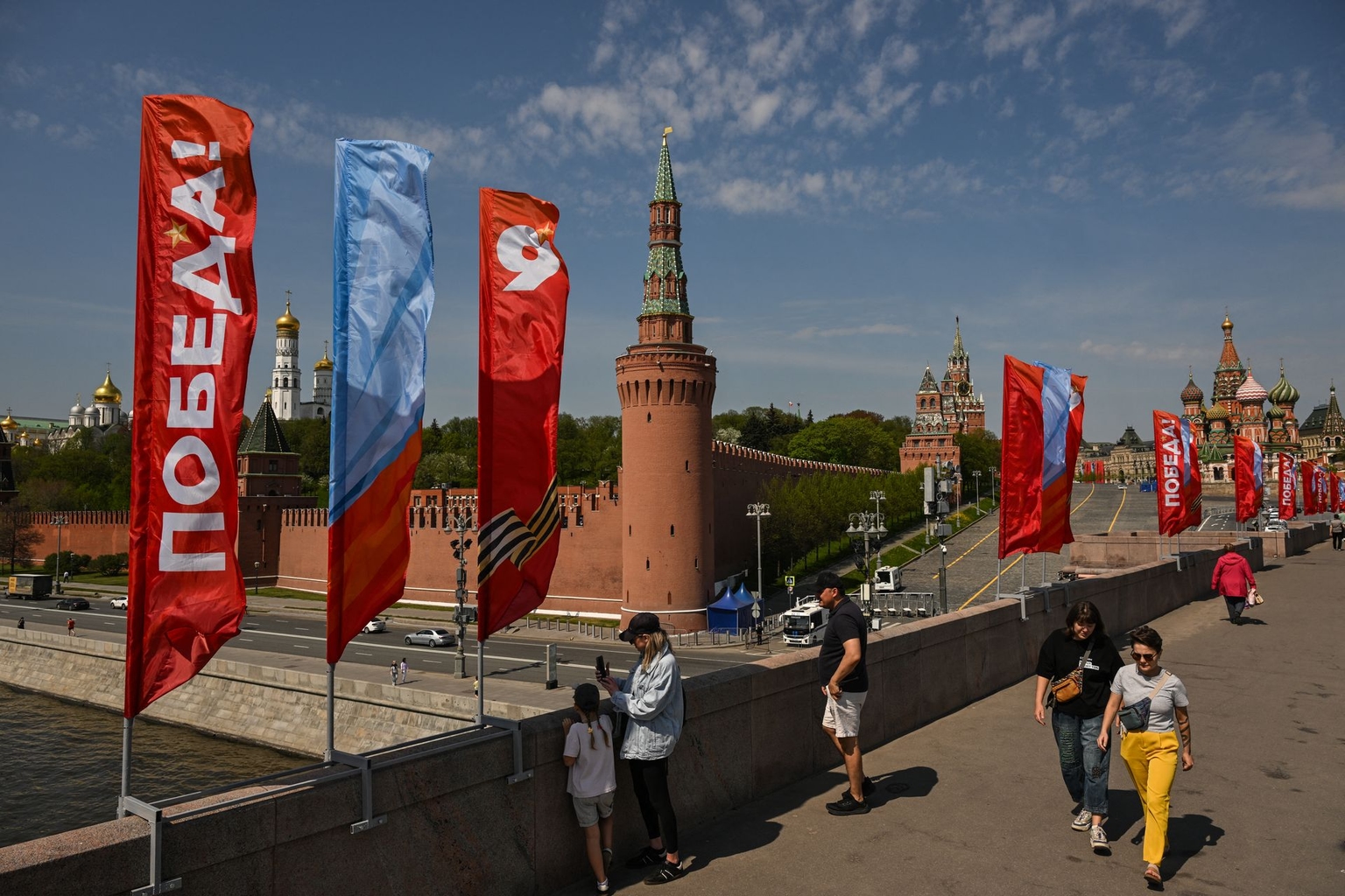 People walk across the Moskvoretsky Bridge, adorned with Victory Day decorations, in Moscow, Russia, on May 6, 2026.