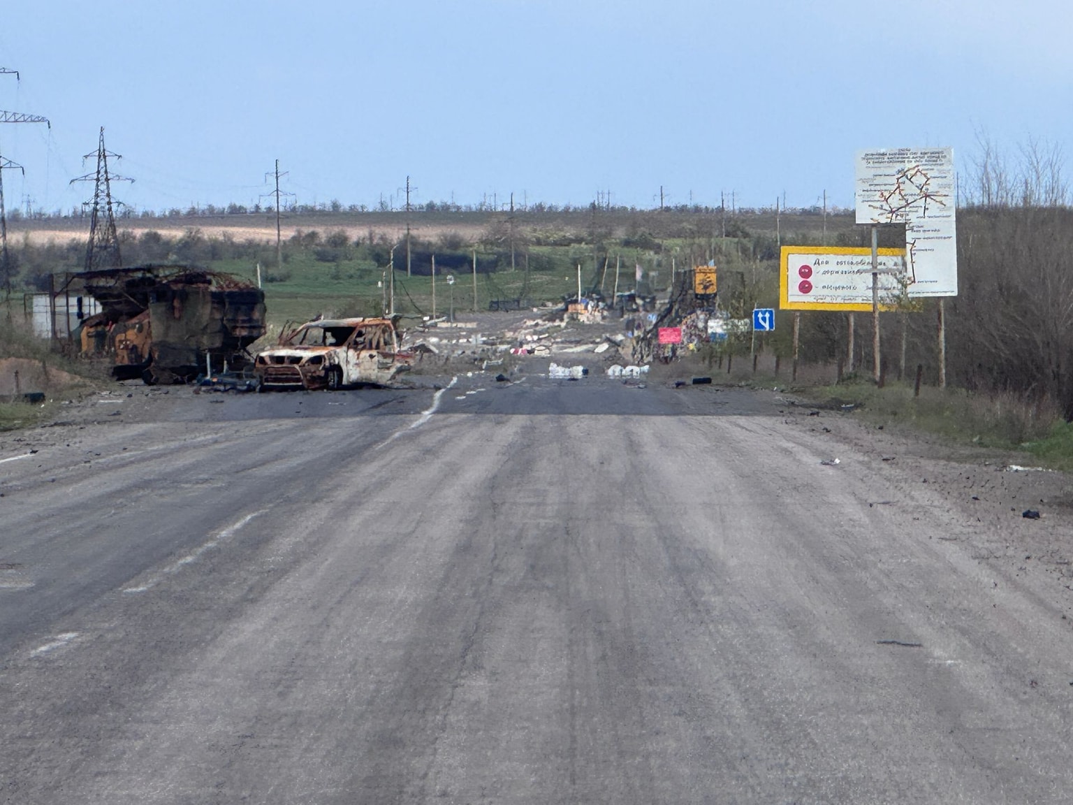 Wreckage of vehicles and debris lie on Pavlohrad-Pokrovsk road next to ‘Donetsk Oblast’ stele at a checkpoint and crossing destroyed by a Russian airstrike on April 28, 2026 in Donetsk Oblast (Alex Nikitenko/Global Images Ukraine via Getty Images)