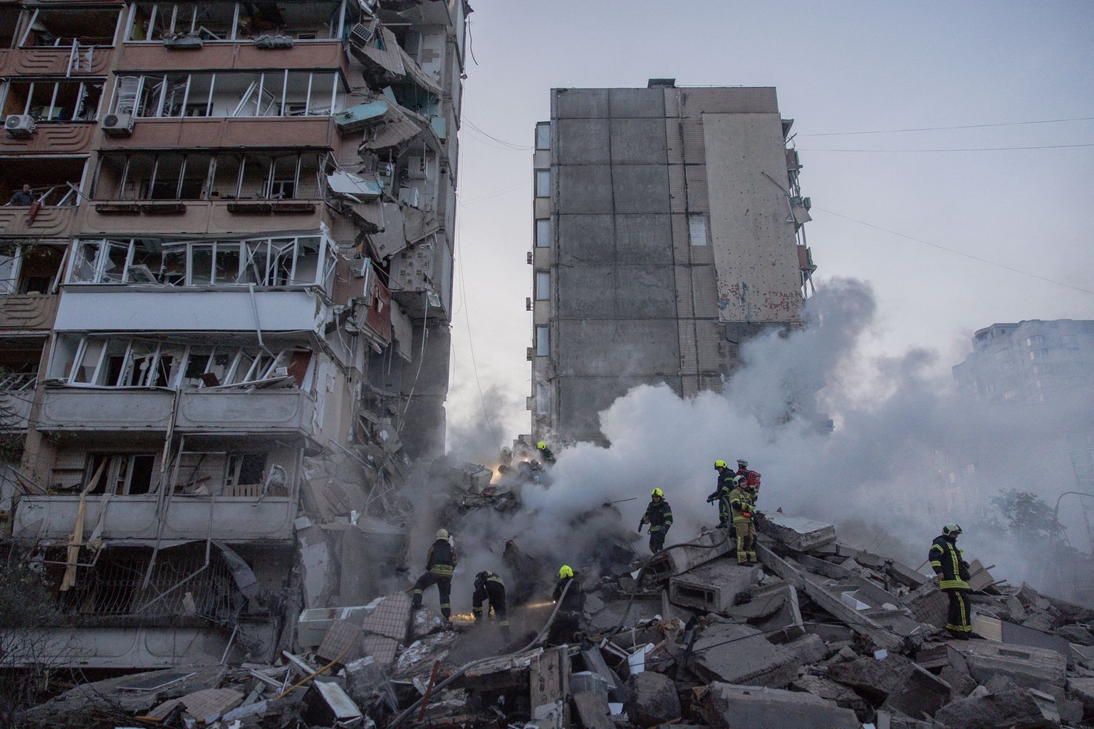 Rescuers work at a residential building partially destroyed following Russian drone and missile strikes in Kyiv, Ukraine, on May 14, 2026.