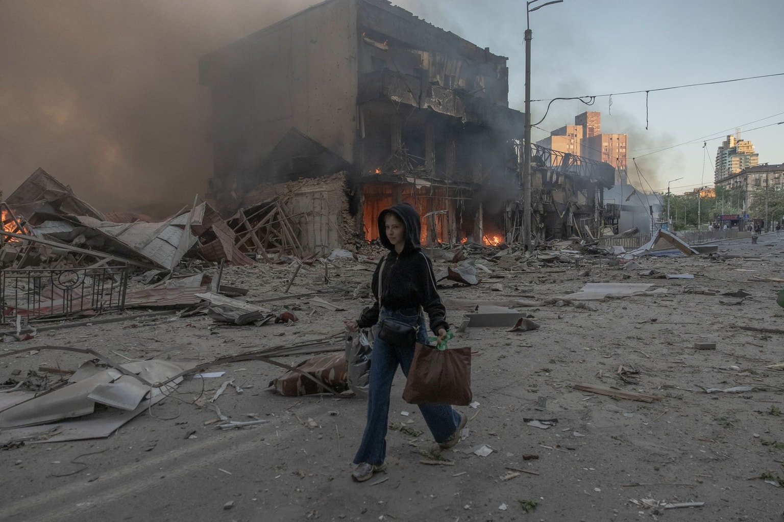 A woman walks past heavily damaged buildings following Russian strikes in Kyiv, Ukraine, on May 24, 2026.