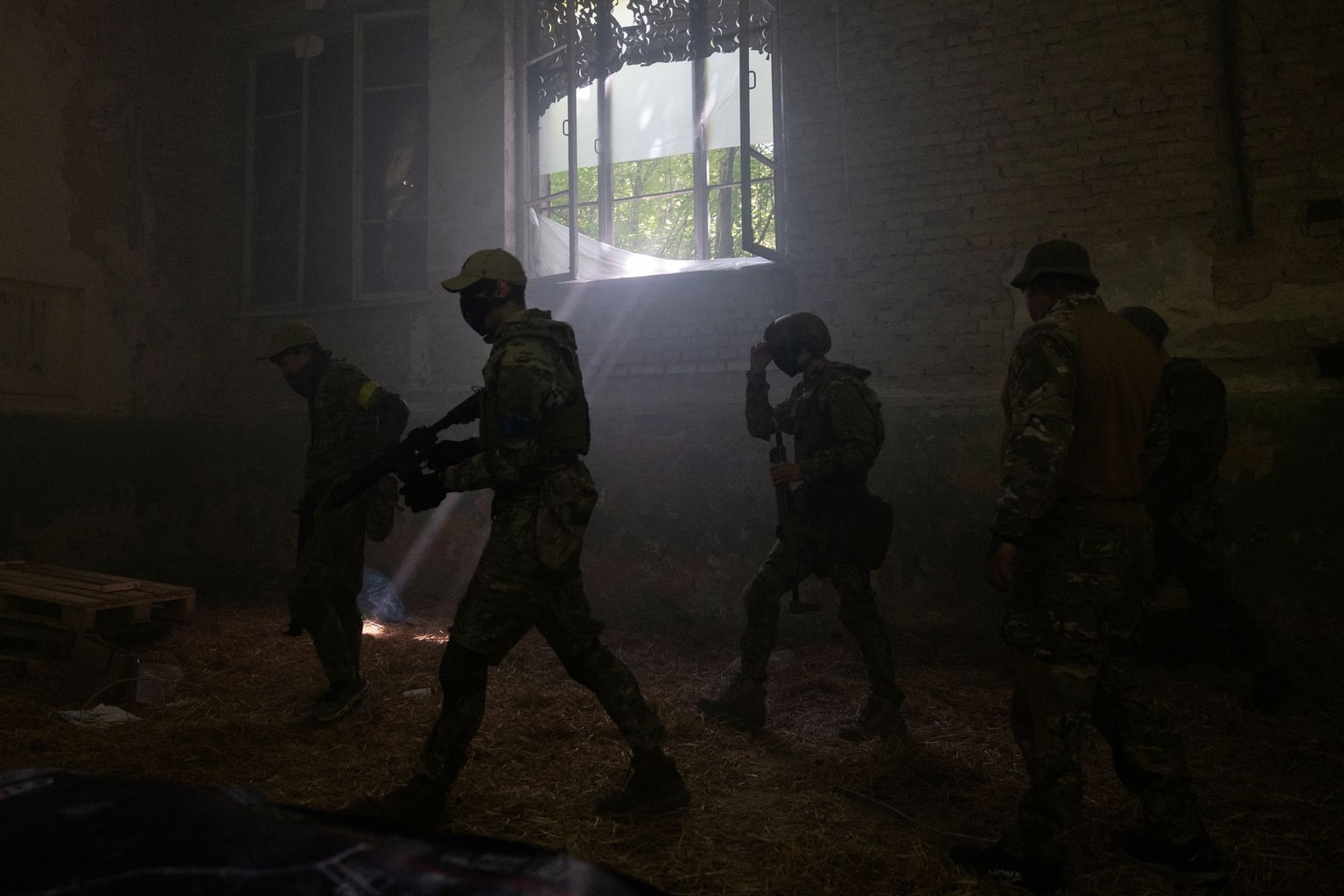 Civilians wearing military uniforms take part in a training organized by soldiers of the Third Separate Assault Brigade in Kyiv Oblast, Ukraine, on July 12, 2025. (Tetiana Dzhafarova / AFP / Getty Images)