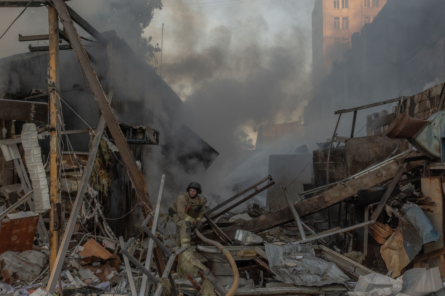 A firefighter works at the site next to a multi-storey residential building damaged following massive Russian missile and drone strikes in Kyiv, Ukraine, on June 2, 2026. (Roman Pilipey / AFP via Getty Images)