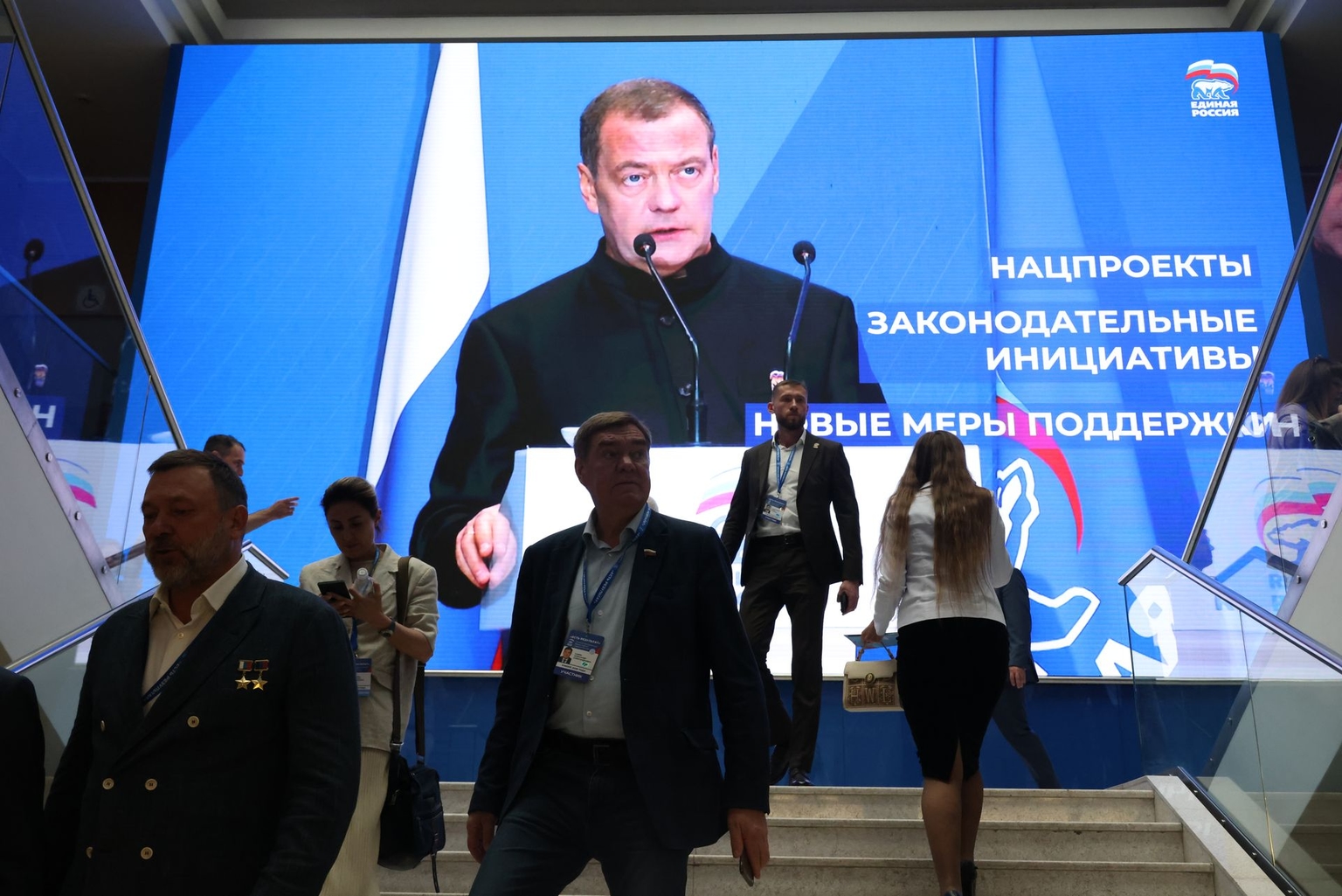 People walk next to a screen showing former Russian President Dmitry Medvedev in Moscow, Russia, on June 9, 2026.