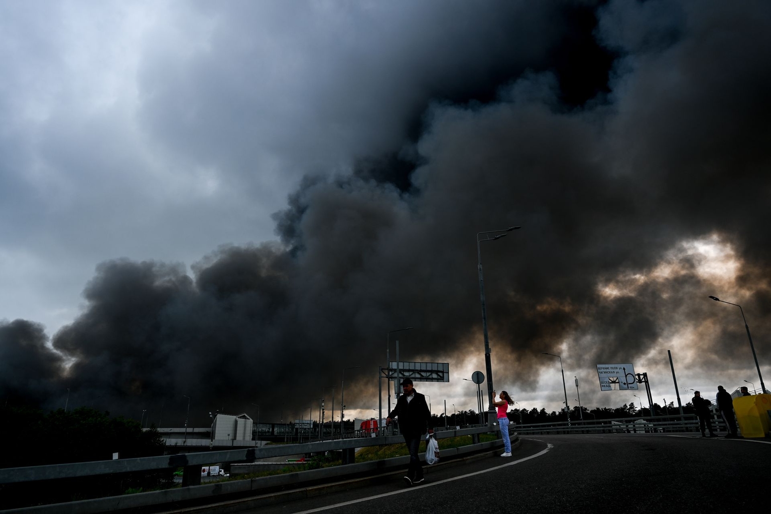 Black smoke rises from the refinery as firefighting efforts continue following a Ukrainian drone strike in Moscow, Russia, on June 18, 2026.