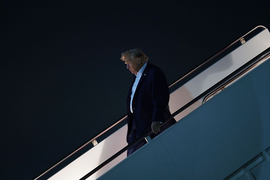 U.S. President Donald Trump walks down a flight of airstairs