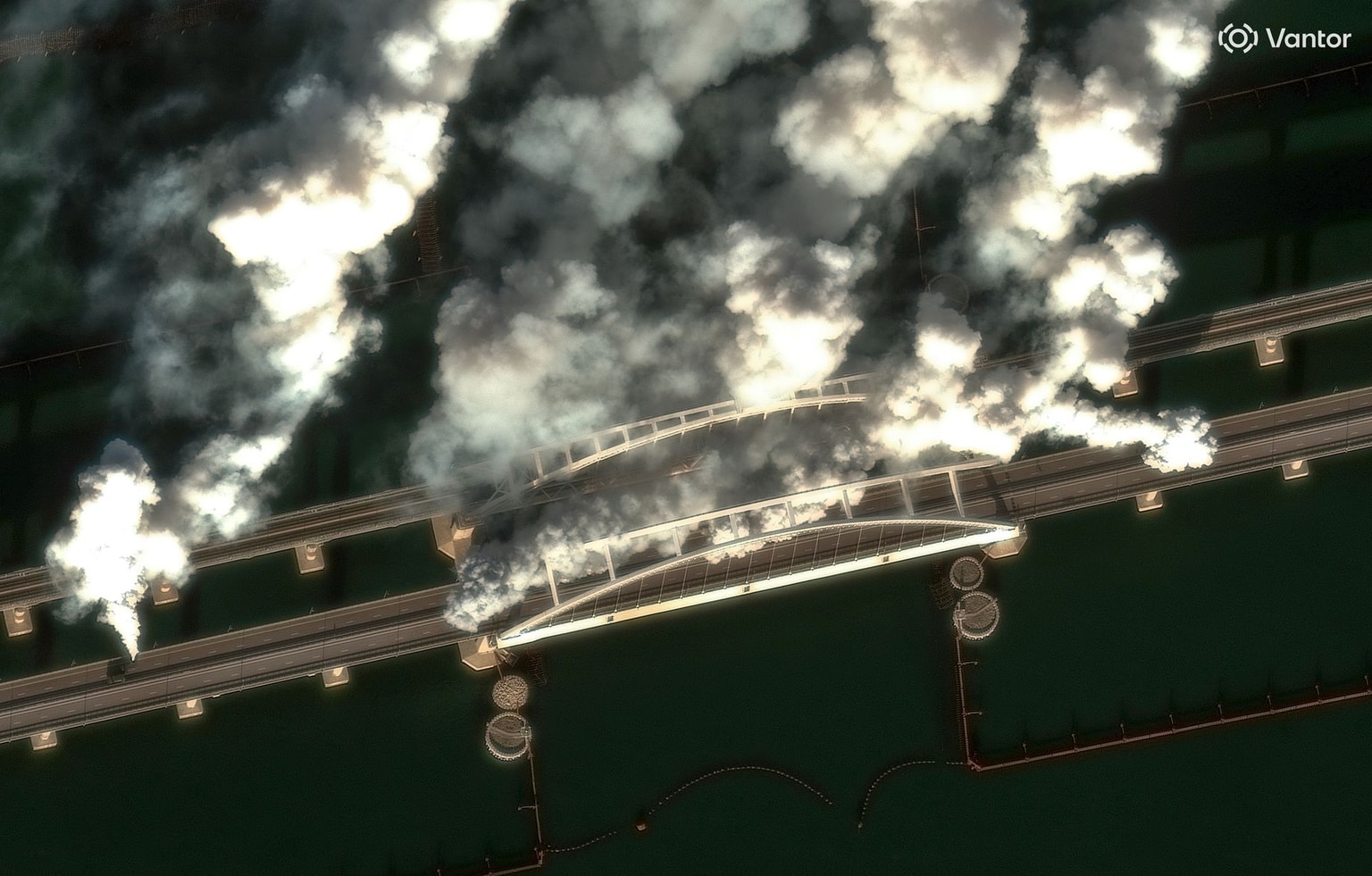 A satellite image shows multiple smoke-generating vehicles operating on the Crimea Bridge, which crosses the Kerch Strait, on June 22, 2026, obscuring parts of the roadway and bridge. (Vantor / Getty Images)