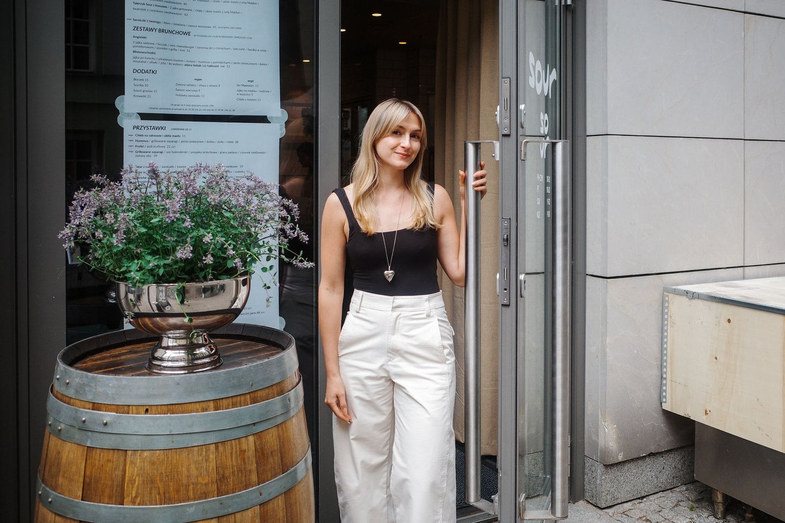 Ksenia Mazur, owner of Sour, poses in front of her restaurant in Warsaw, Poland, on May 28, 2026. (Noémie Naudin / The Kyiv Independent)