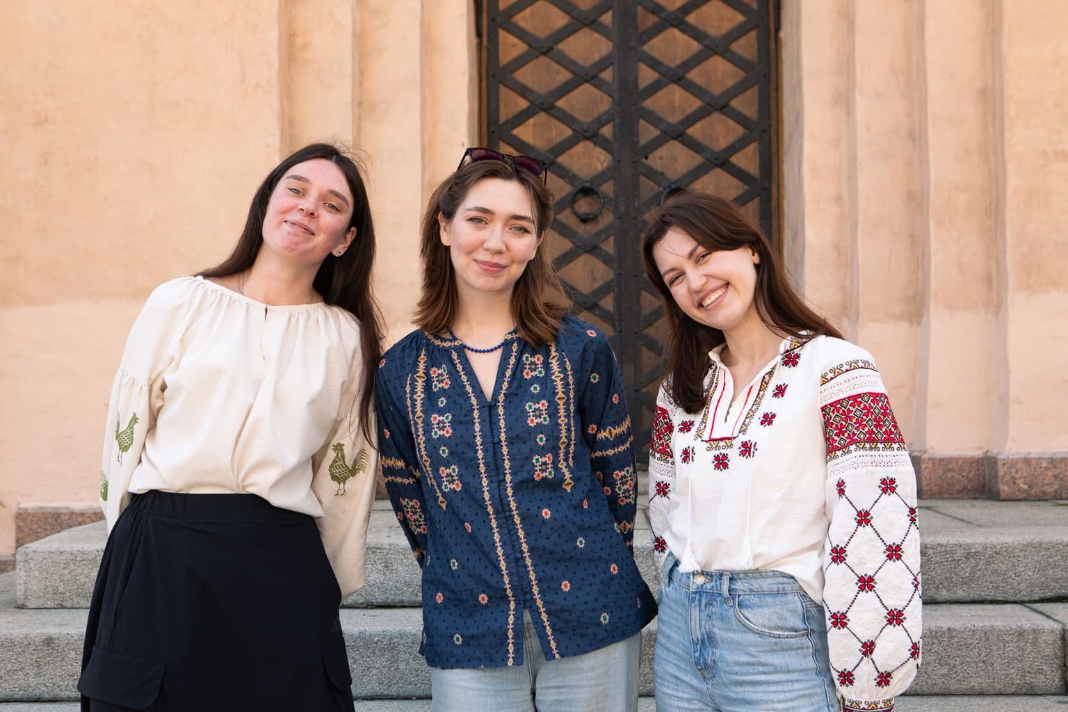 Three women wearing different styles of vyshyvanka, traditional embroidered shirt in Ukraine