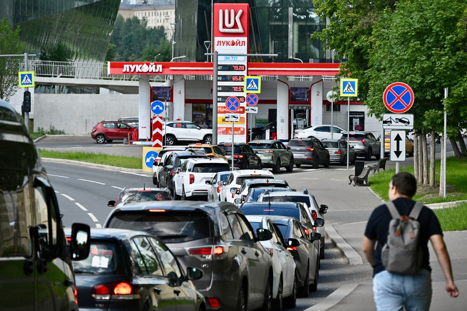 People queue to refuel their cars at a Lukoil petrol station in Moscow, Russia, on June 30, 2026.