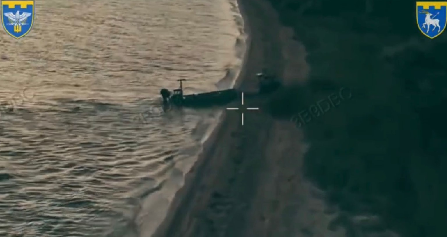A Ukrainian sea drone delivers a ground drone on the shore of the Kinburn Split in a video released July 13, 2026 (Telegram)