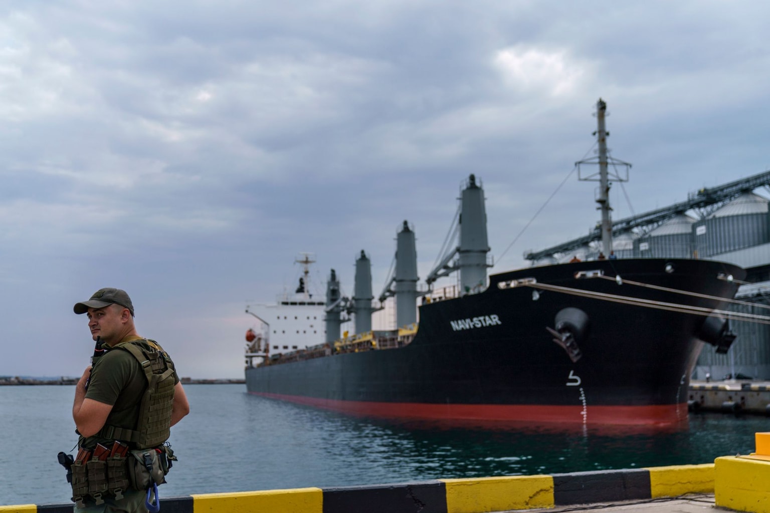 A security officer stands next to the grain ship Navi-Star at the Odesa Sea Port in Odesa, Ukraine, on July 29, 2022. (David Goldman / AP)