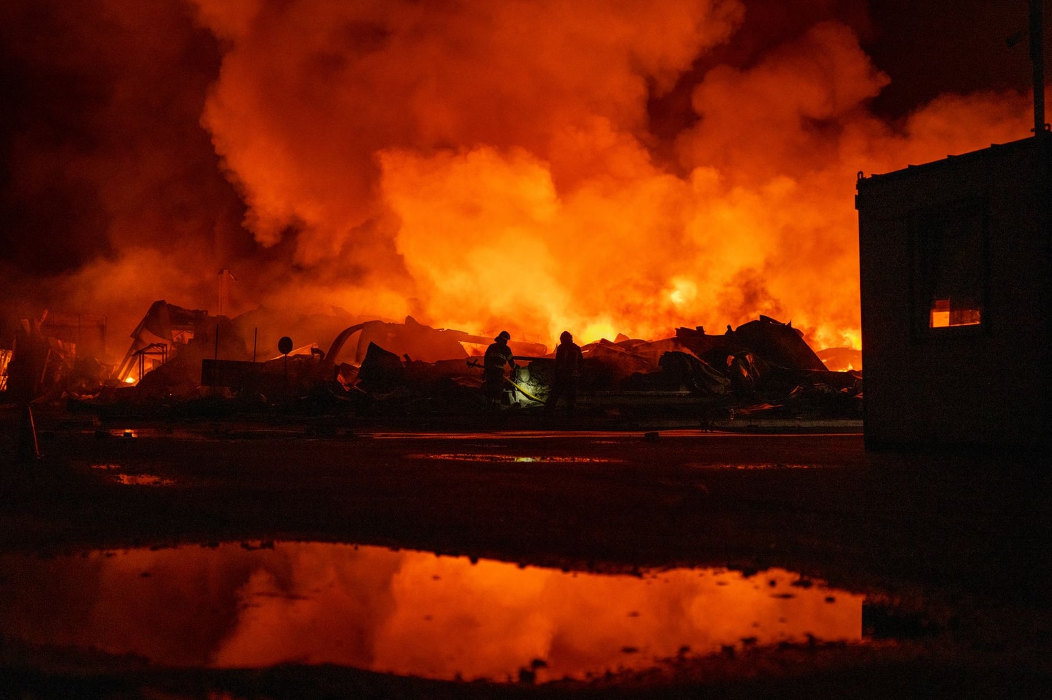 Firefighters put out a fire after Russian missiles hit a warehouse in Kyiv, Ukraine, on Aug. 5, 2026. (Dan Bashakov / AP)