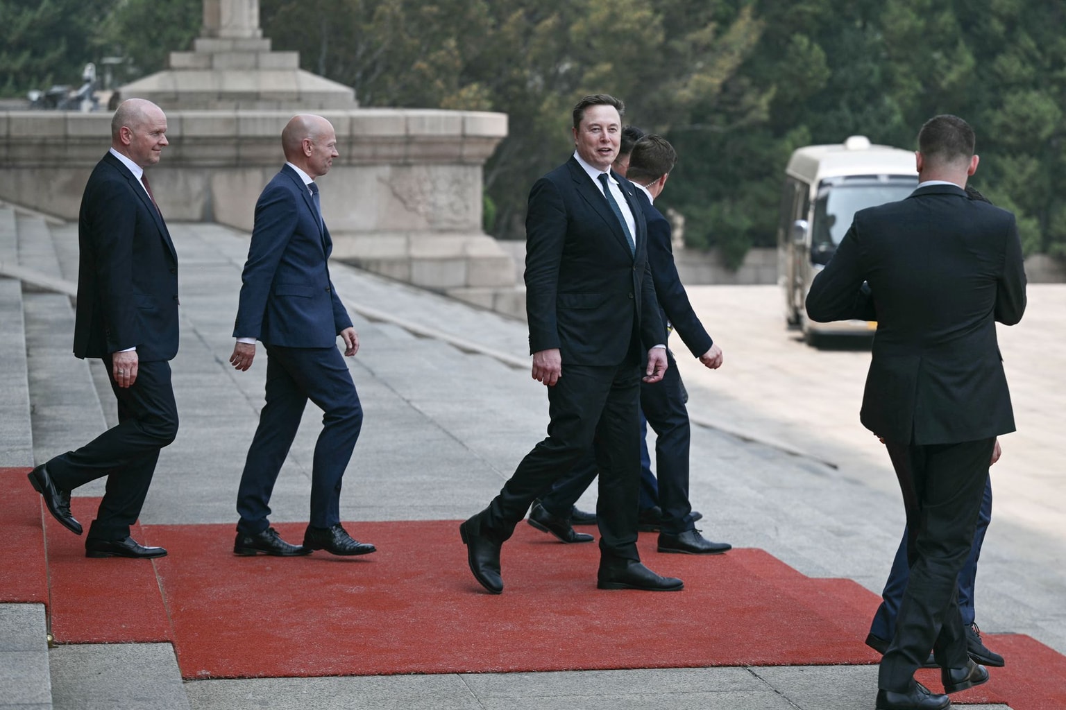 Tesla and SpaceX CEO Elon Musk (C) walks after a welcome ceremony for US President Donald Trump at the Great Hall of the People in Beijing on May 14, 2026. (Photo by Brendan Smialowski / AFP via Getty Images)
