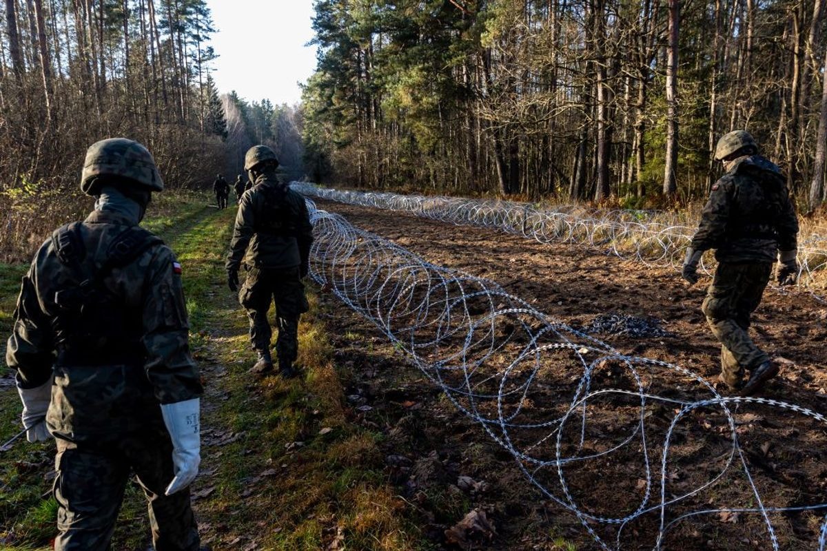 Polish soldiers install concertina wire at Poland's border with the Russian exclave of Kaliningrad in Goldap, Poland, on Nov. 14, 2022. (Paulius Peleckis / Getty Images)