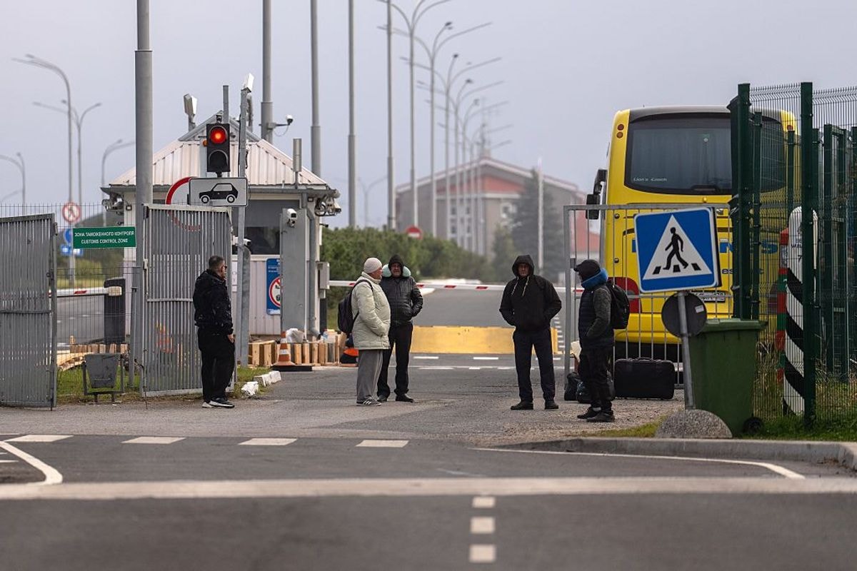 People wait inside Russia after crossing from Estonia at the Luhamaa border crossing on October 3, 2025 in Luhamaa, Estonia. (Carl Court/Getty Images)