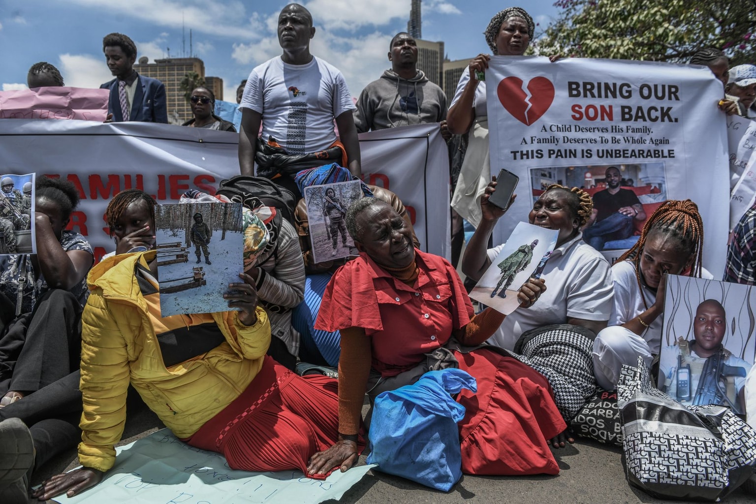 Families of Kenyans allegedly recruited illegally to fight for Russia in its war against Ukraine hold photos of their missing relatives during a protest demanding answers and their return, in Nairobi, Kenya, on March 5, 2026. (Gerald Anderson / Anadolu via Getty Images)
