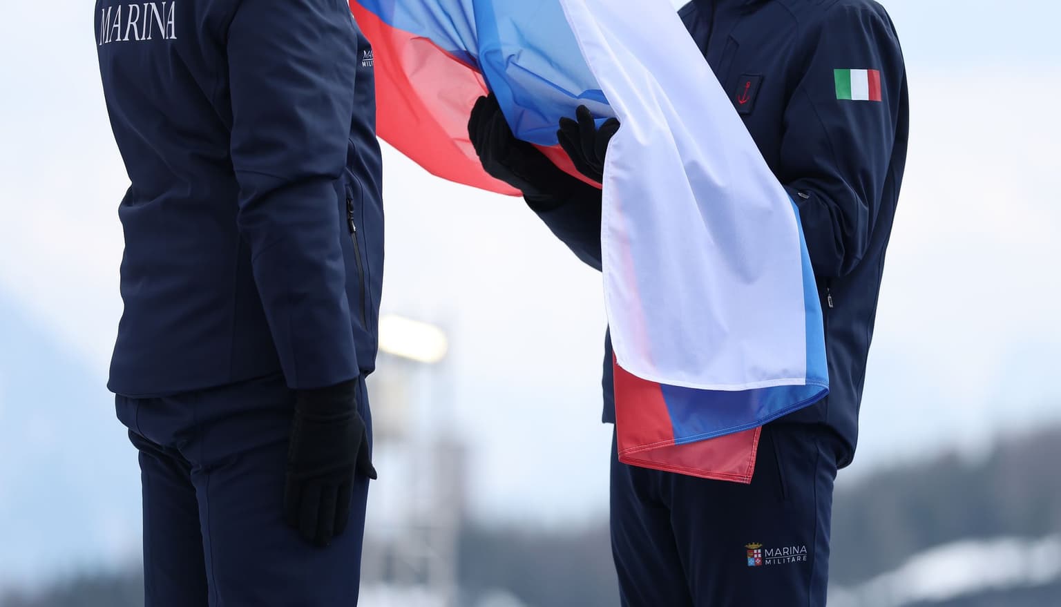 Russian flag is prepared for raising during a Paralympic medal ceremony in Cortina d'Ampezzo, Italy, on March 9, 2026.