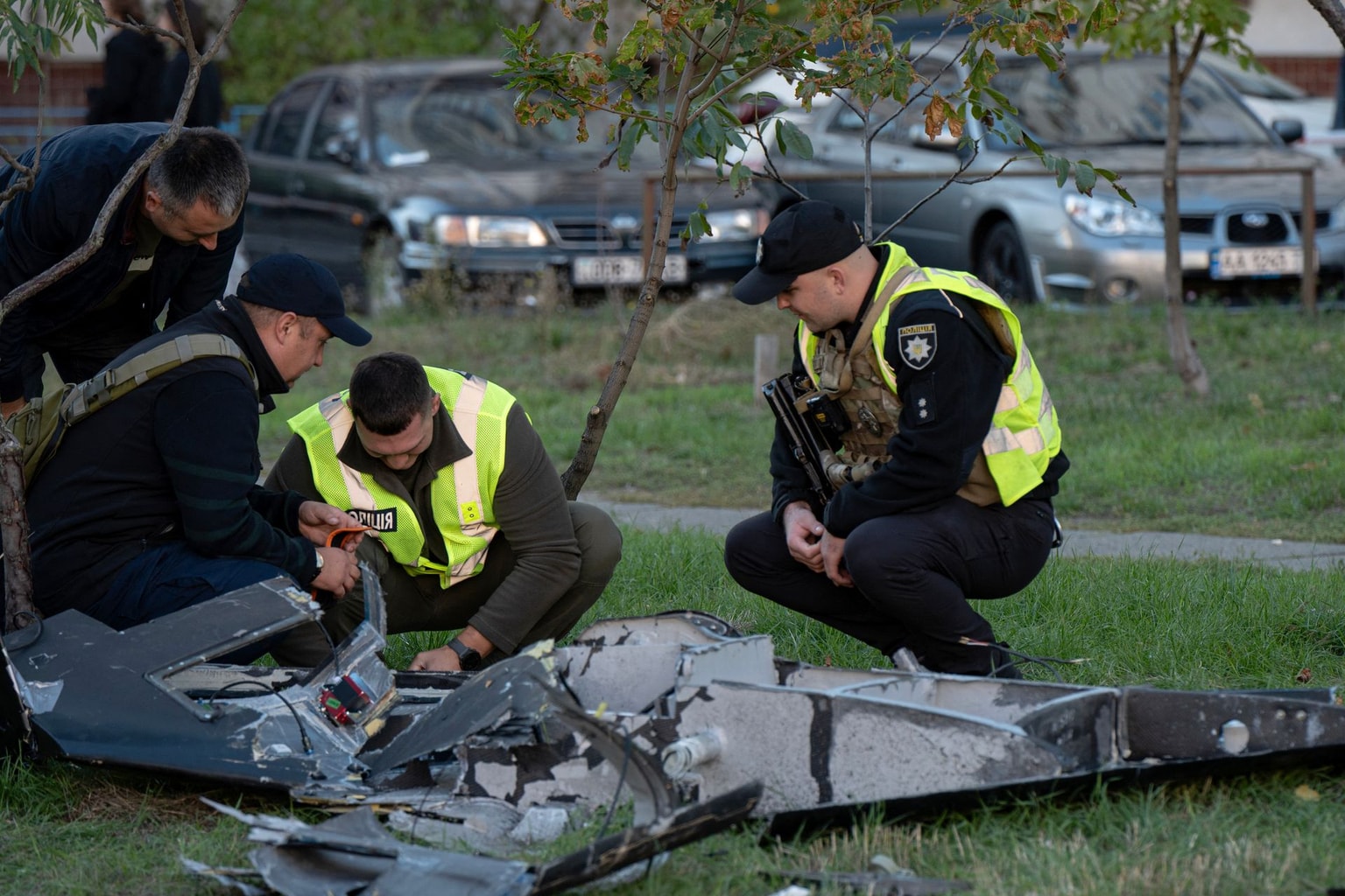 Ukrainian police investigators examine debris of a Russian drone that crashed near a children's playground among residential buildings and did not detonate, in Kyiv on September 30, 2026, amid the Russian invasion of Ukraine. (Photo by Genya SAVILOV / AFP via Getty Images)