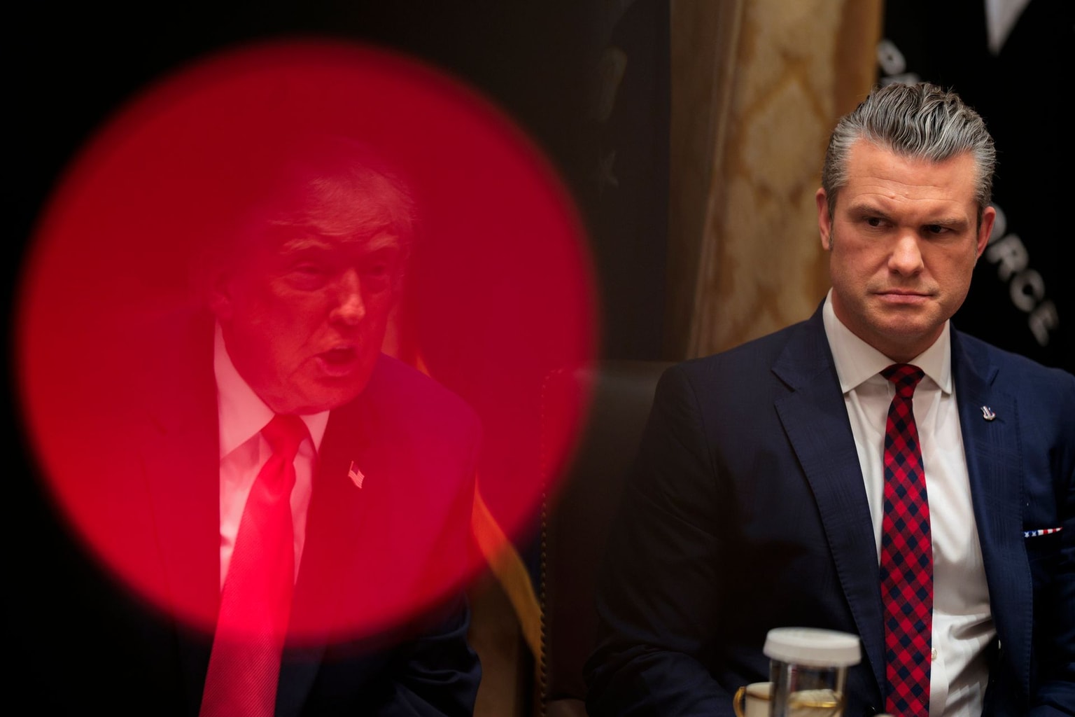 U.S. President Donald Trump (L) speaks as U.S. Defense Secretary Pete Hegseth (R) looks on during a meeting in the Cabinet Room of the White House in Washington, D.C., U.S., on Dec. 2, 2025. (Chip Somodevilla / Getty Images)