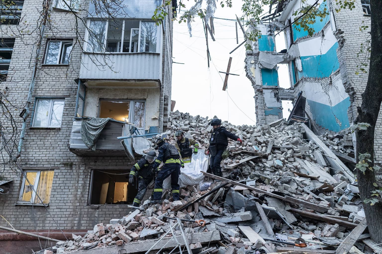 Firefighters recover the body of an elderly woman from the rubble in Sloviansk, Donetsk Oblast, Ukraine, on Oct. 17, 2026.