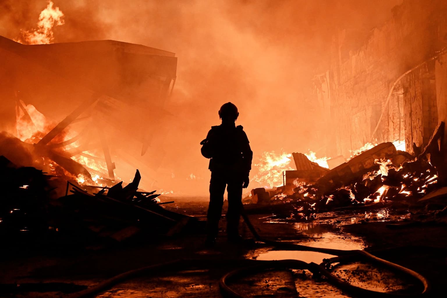A firefighter extinguishes a fire after a Russian drone strike in Kharkiv, Ukraine, on Oct. 28, 2026.